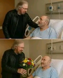 No one expected to see Paul McCartney quietly walking down the stark hospital corridor, but there he was — carrying a small bouquet of daisies and his guitar — coming to visit his dear friend Phil Collins, who has been recovering from serious health complications. Witnesses described how the former Beatle paused at the doorway for a moment, taking in the sight of Phil resting in bed, before entering with a gentle smile and saying softly, “Hey mate, thought I’d bring a little music with me.” He.